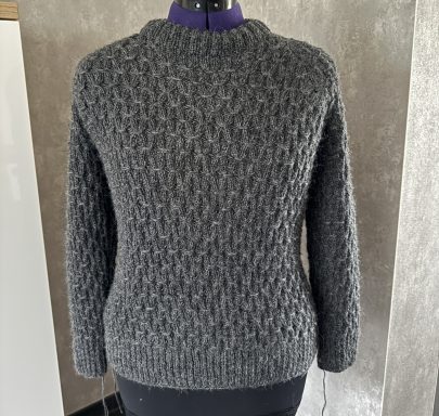 Grauer Pullover mit strukturiertem Muster und Rundhalsausschnitt.